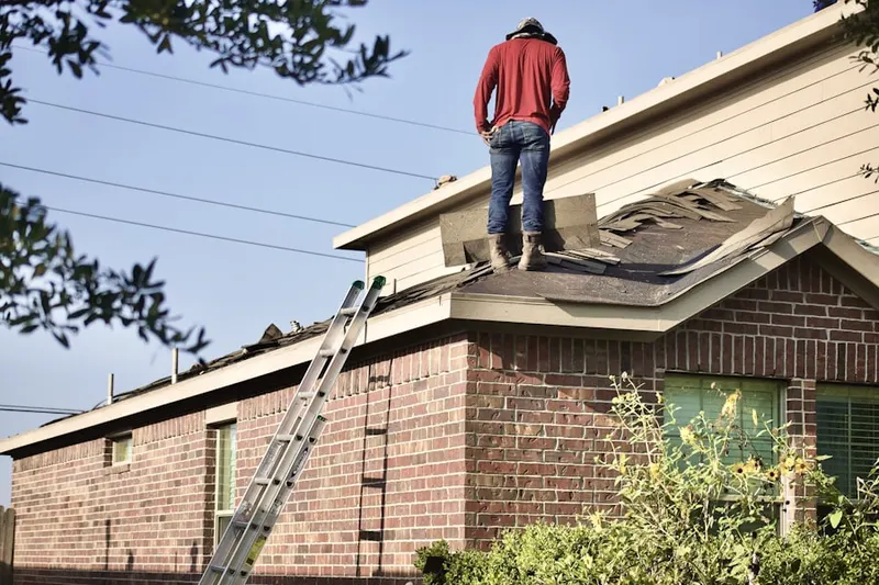 Professional roofer working on a residential roof in North Holladay